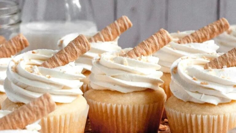 Fluffy gluten-free coconut cupcakes topped with creamy coconut frosting.