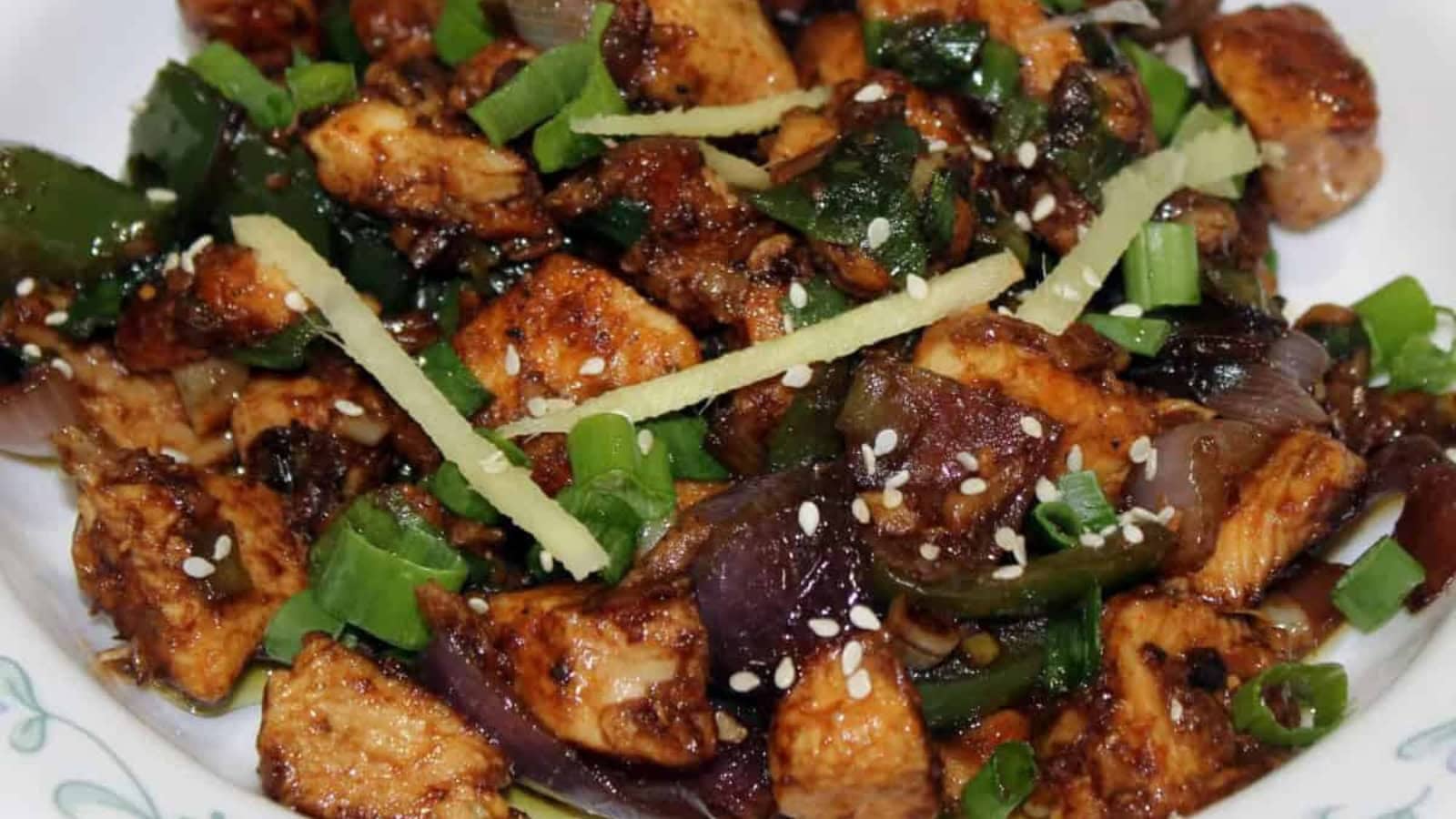 Spicy Indian-style chili chicken stir-fried with peppers and onions.
