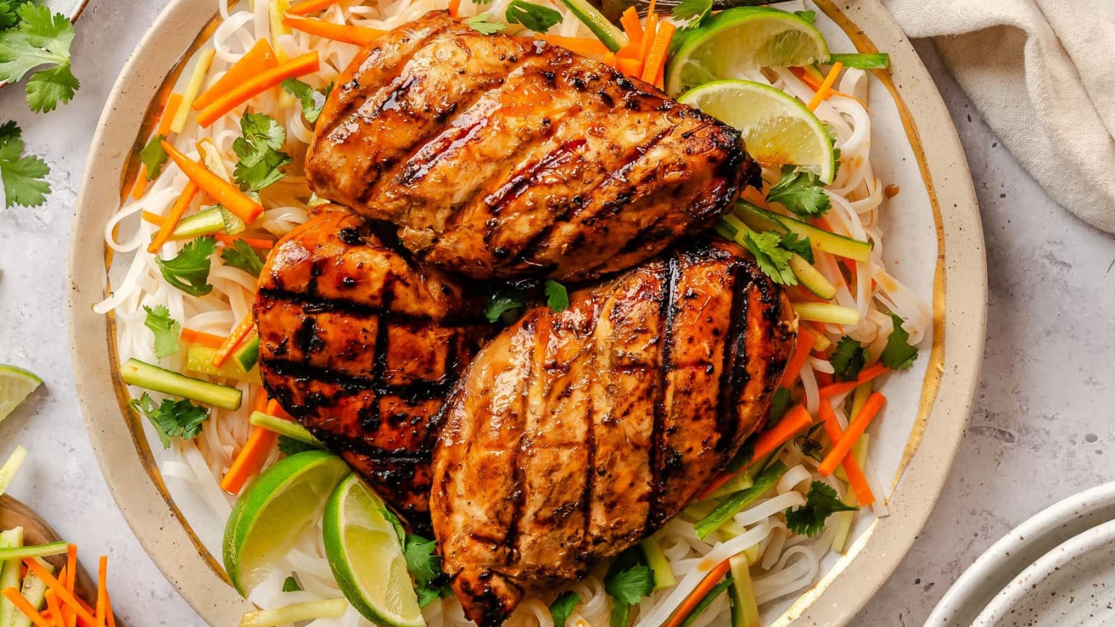 Grilled lemongrass chicken served with fresh herbs and vegetables.