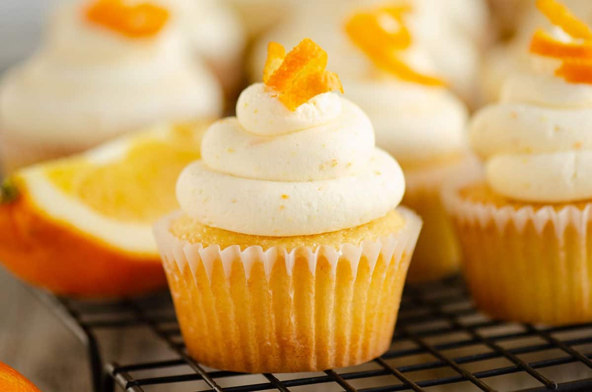Fluffy orange cupcakes topped with creamy citrus frosting.