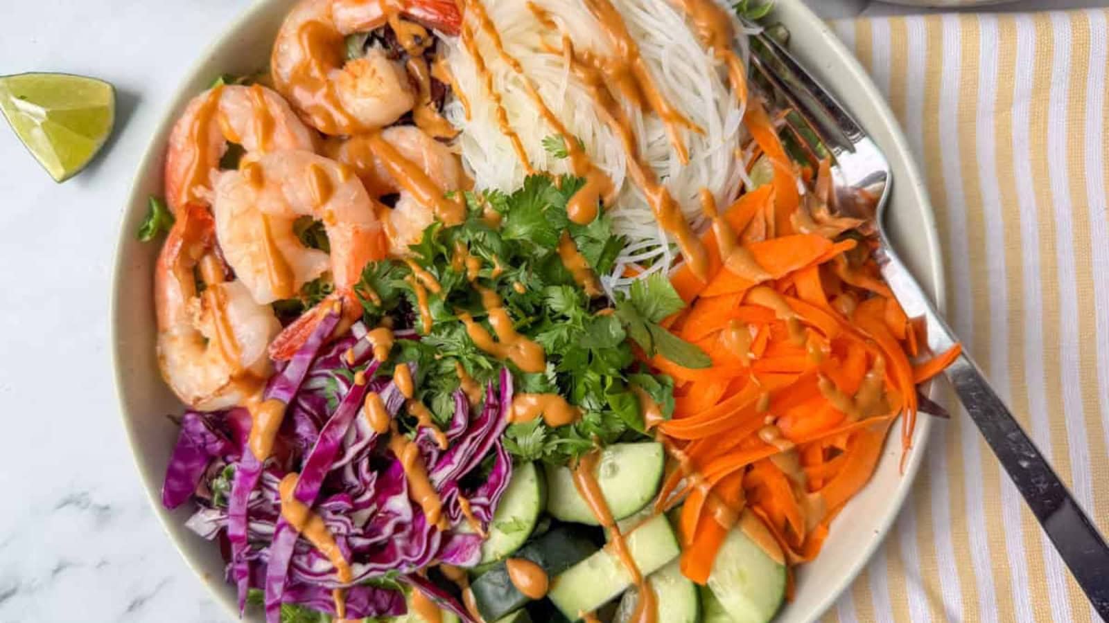 Fresh spring roll salad with crisp vegetables and rice noodles.