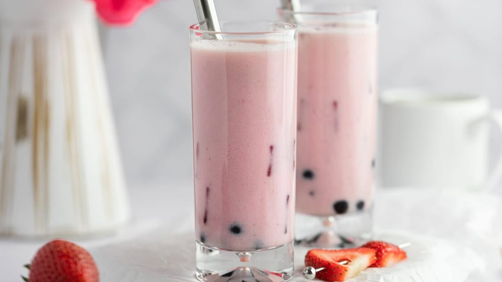 Creamy strawberry milk tea served with ice and boba pearls.