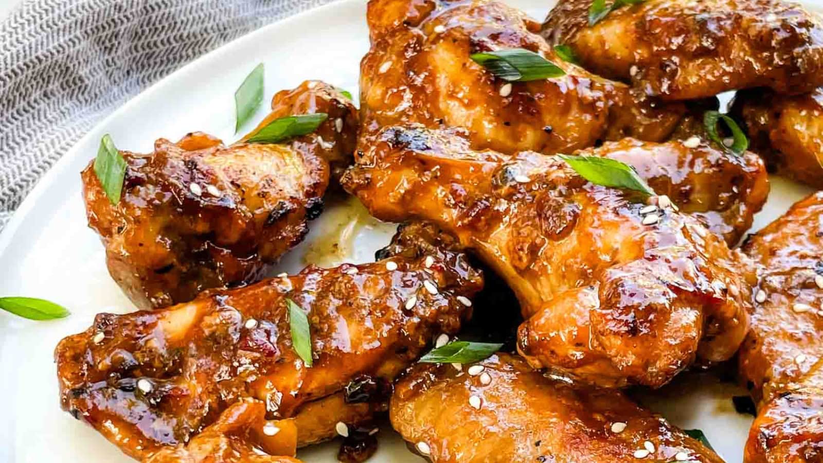 Crispy Thai chicken wings coated in a flavorful sauce.