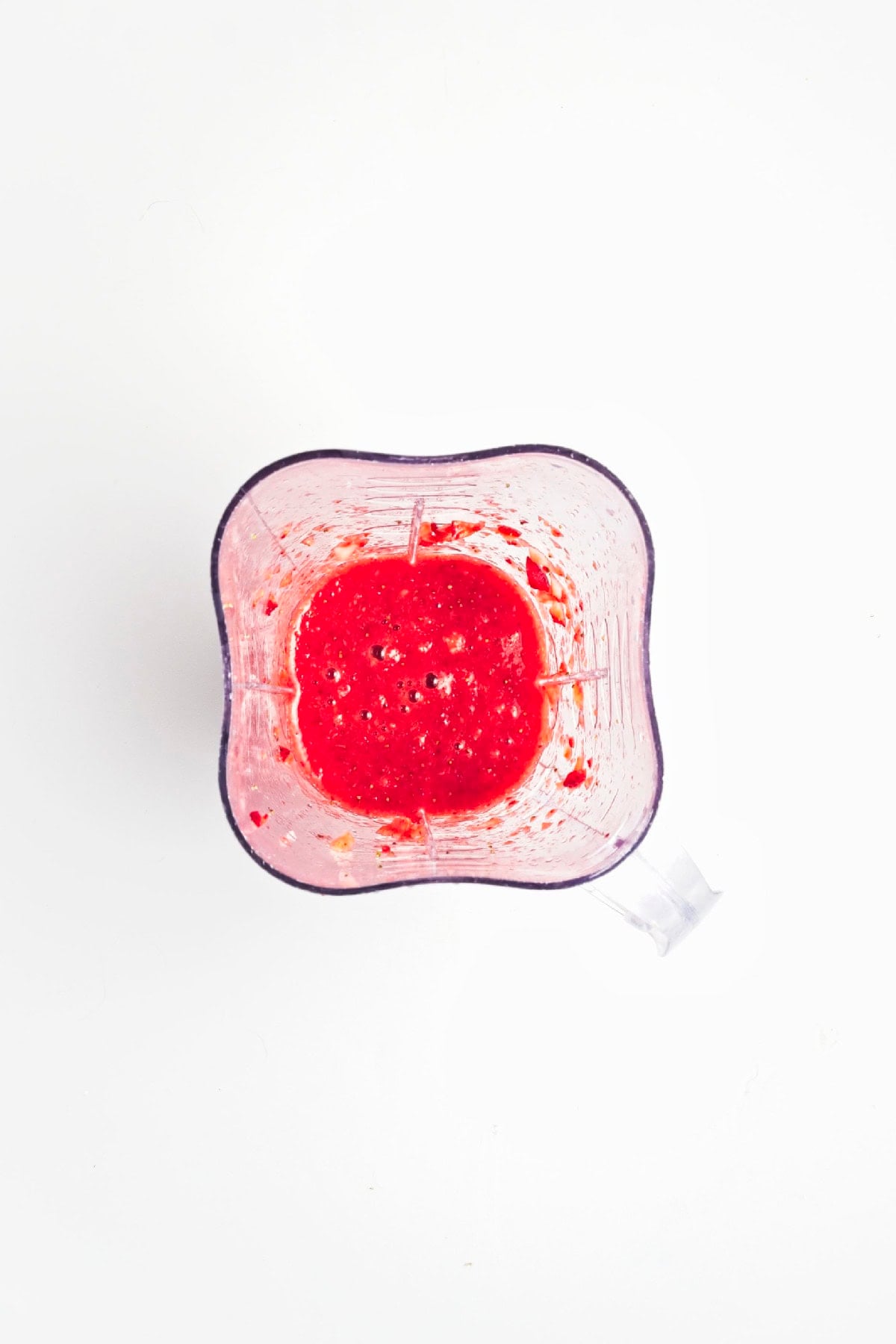 Fresh strawberries blended into a smooth puree for homemade popsicles.
