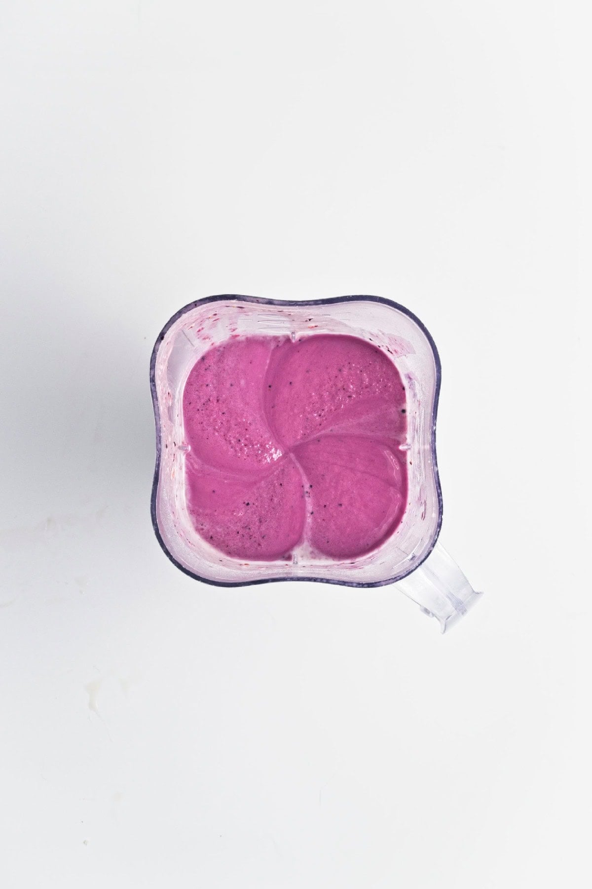 Smooth triple berry mixture blended until creamy for homemade smoothie popsicles.