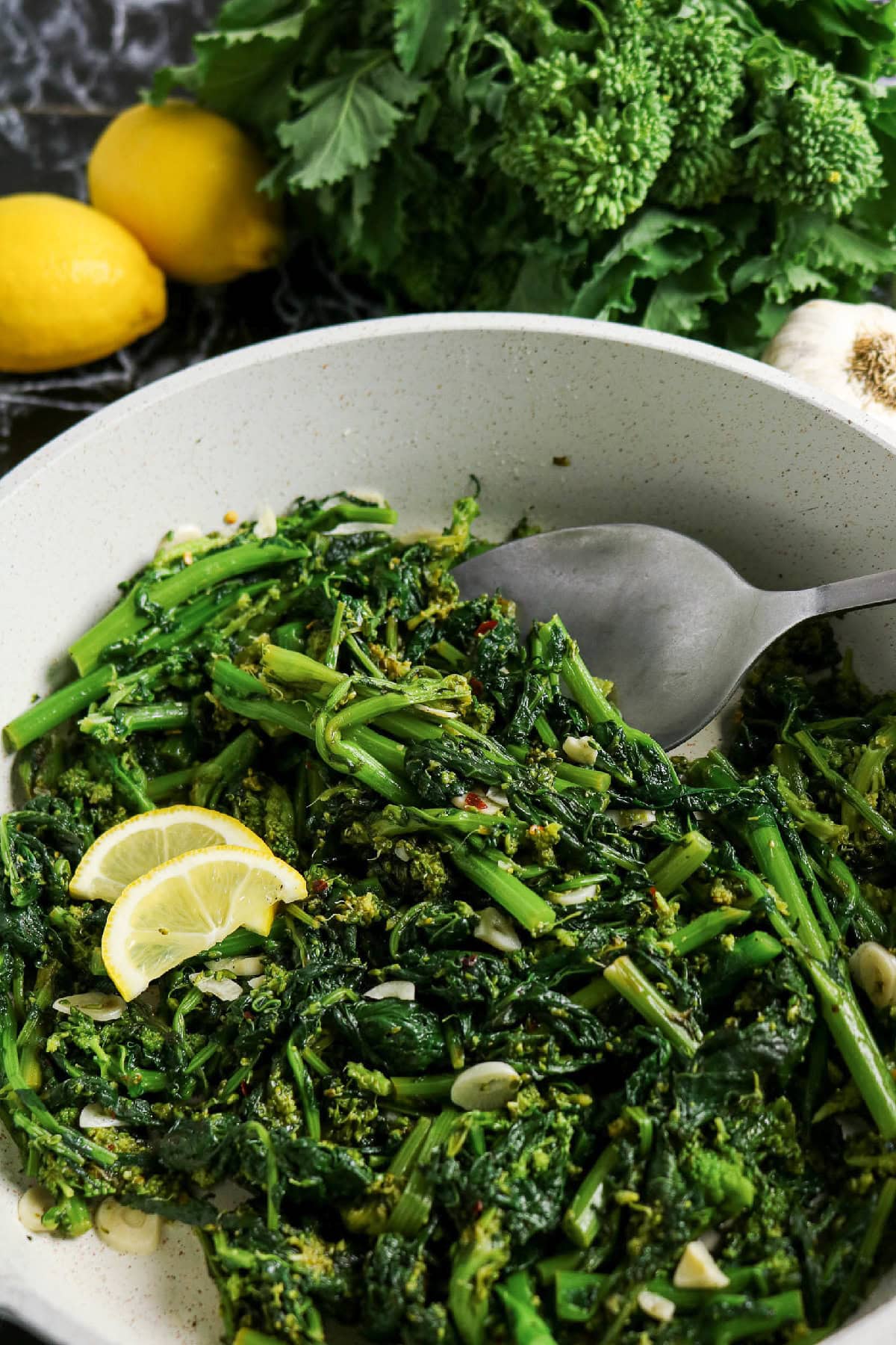Sautéed rapini with garlic and lemon served in a skillet.