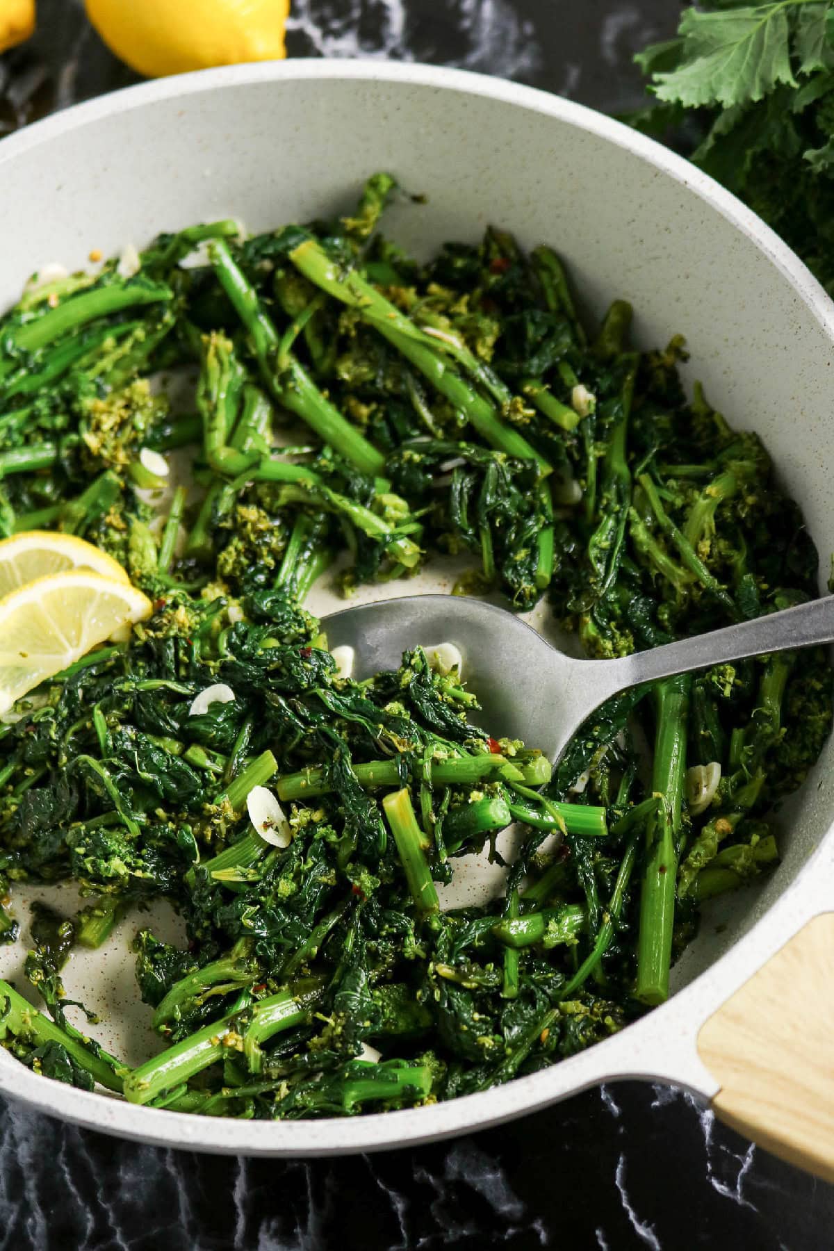 Spoonful of sautéed rapini with garlic and red pepper flakes.