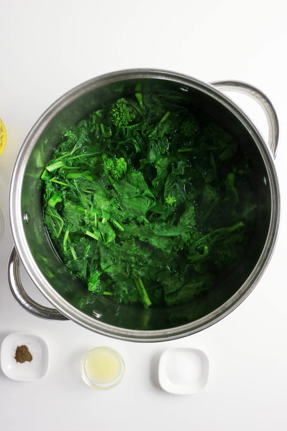 Rapini blanching in a large pot of boiling water.
