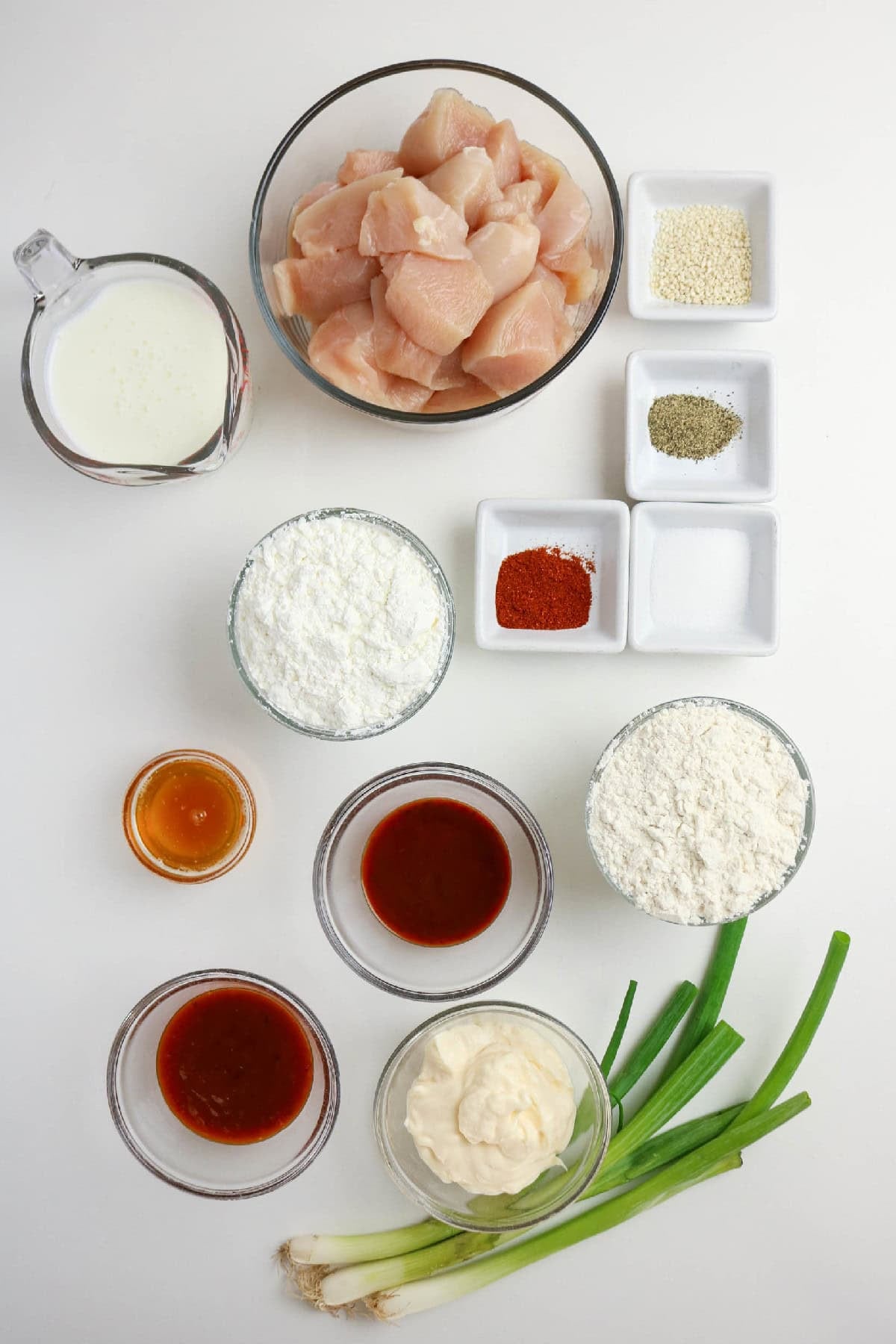 Ingredients for making bang bang chicken arranged on a white surface.
