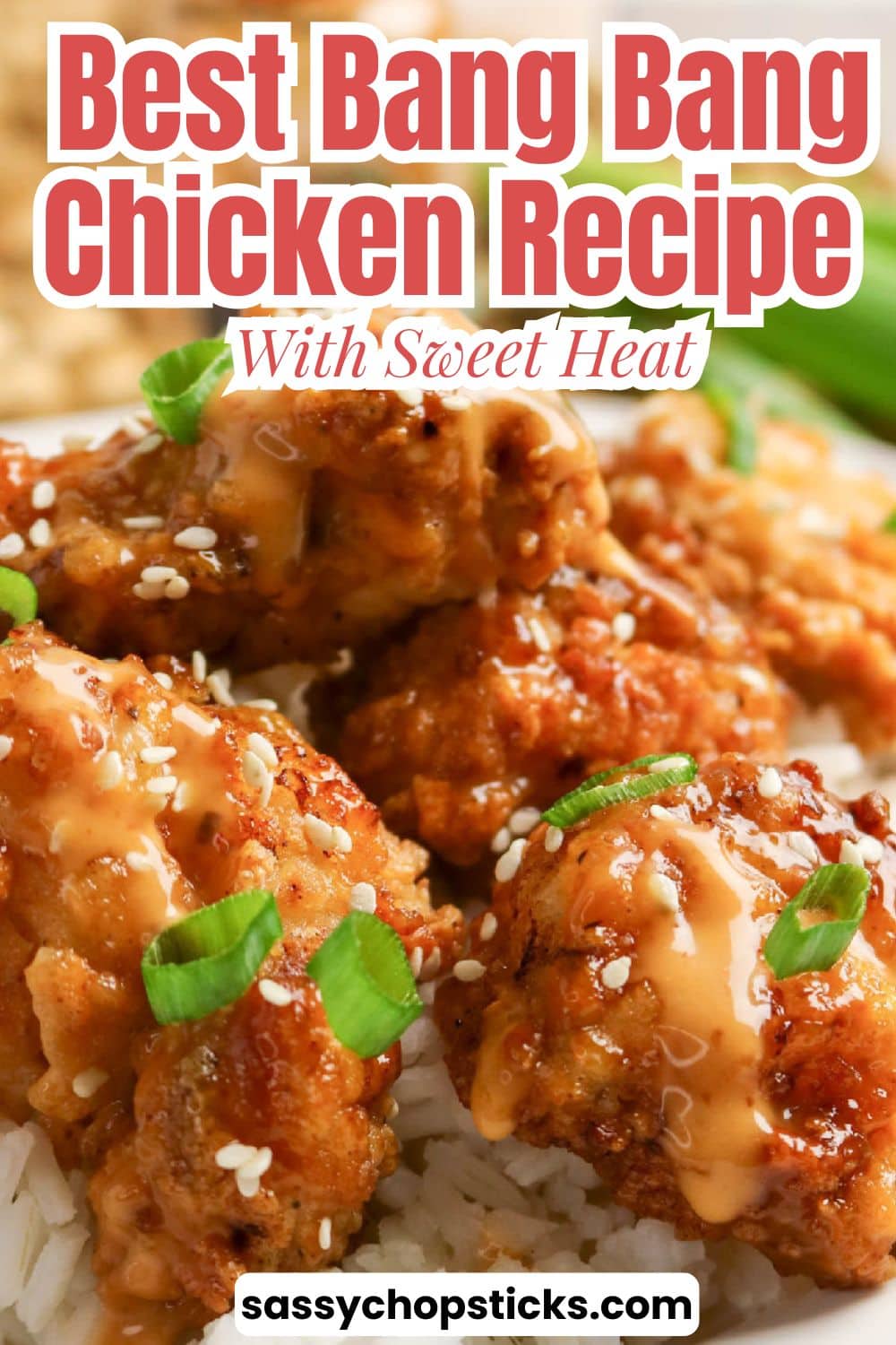 Crispy bang bang chicken with creamy sauce, sesame seeds, and green onions served over white rice.