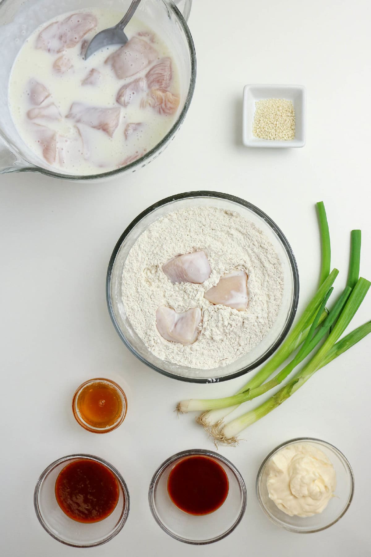Buttermilk-soaked chicken pieces added to the seasoned flour mixture.
