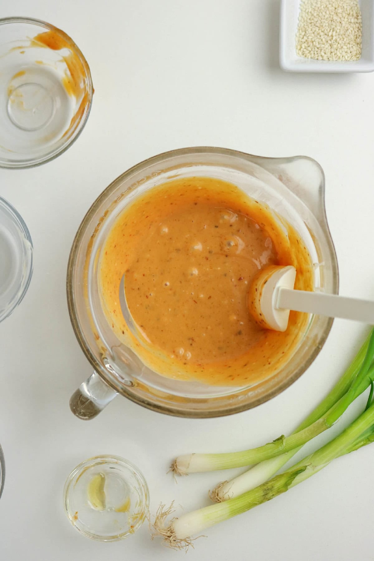 Creamy bang bang sauce mixed together in a glass bowl.