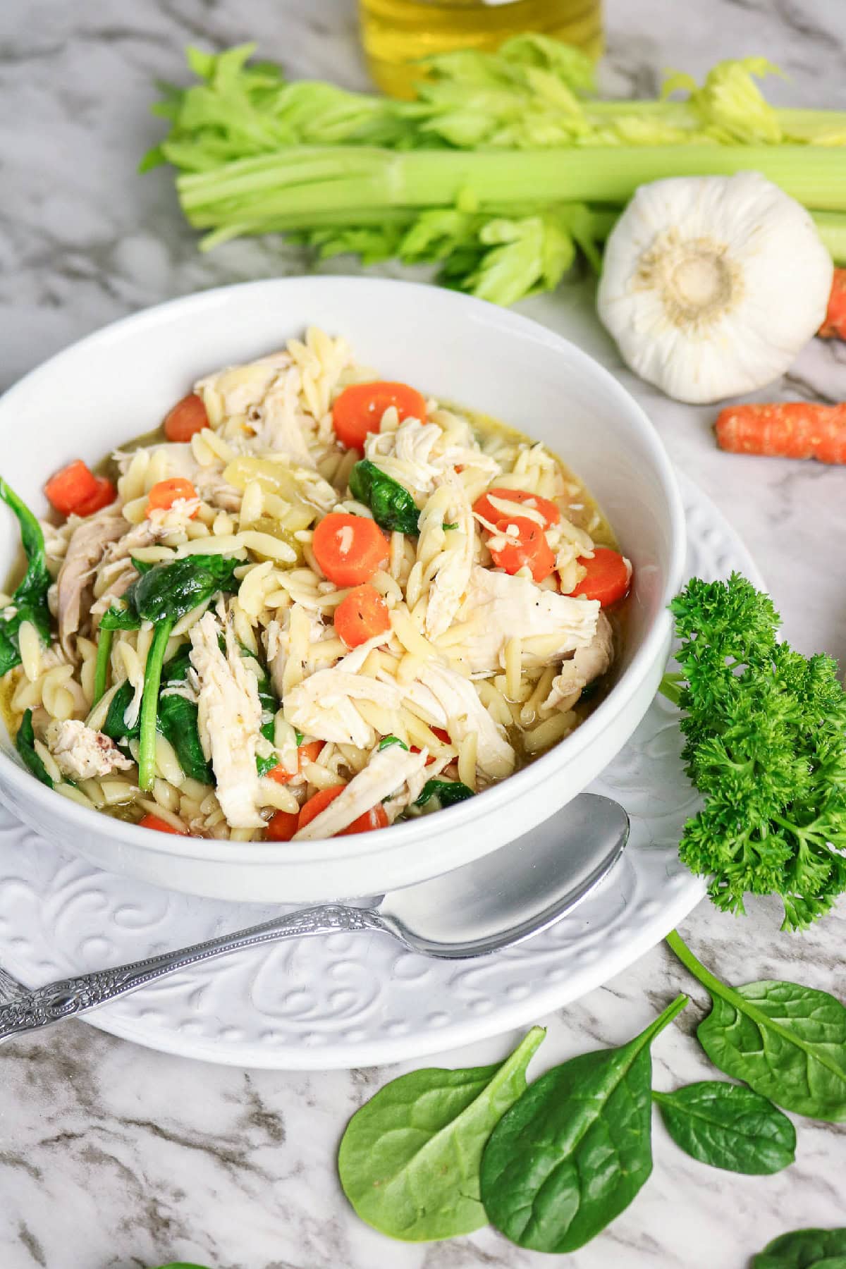 Homemade chicken orzo soup with spinach and carrots.