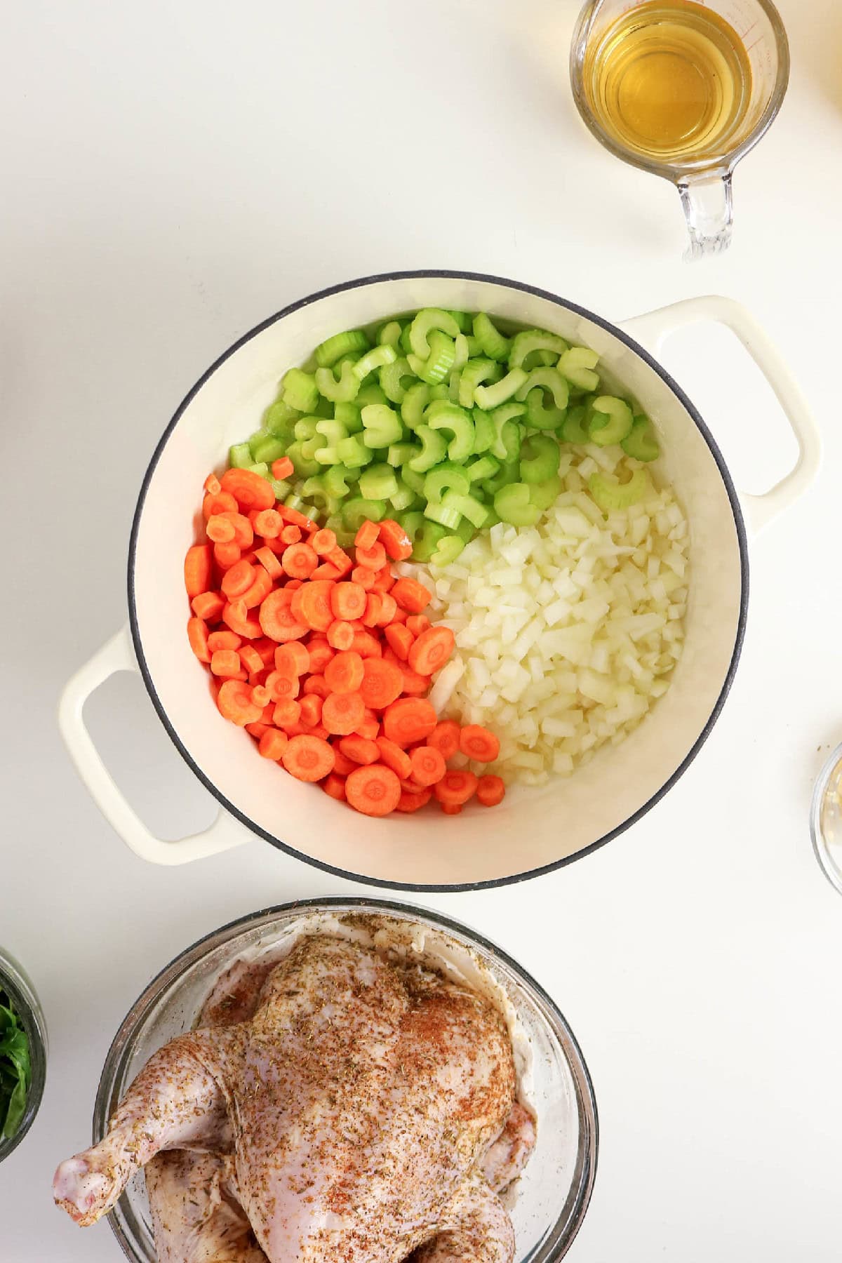 Chopped carrots, celery, and onion added to a Dutch oven.