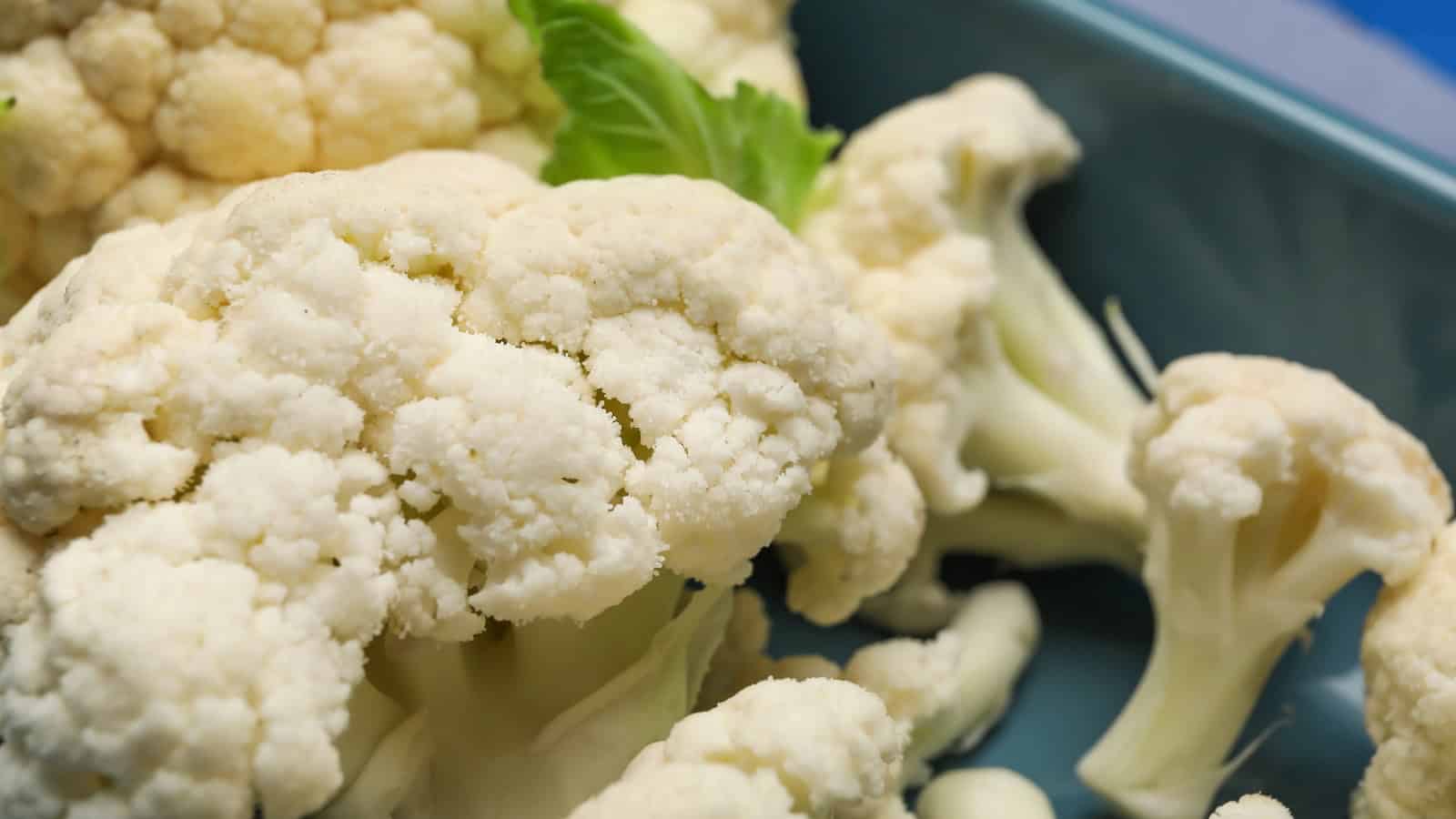Fresh cauliflower florets on a plate.