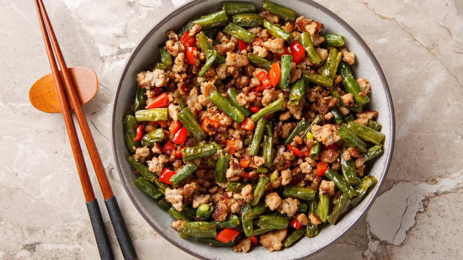 Stir-fried green beans with ground pork and red peppers.