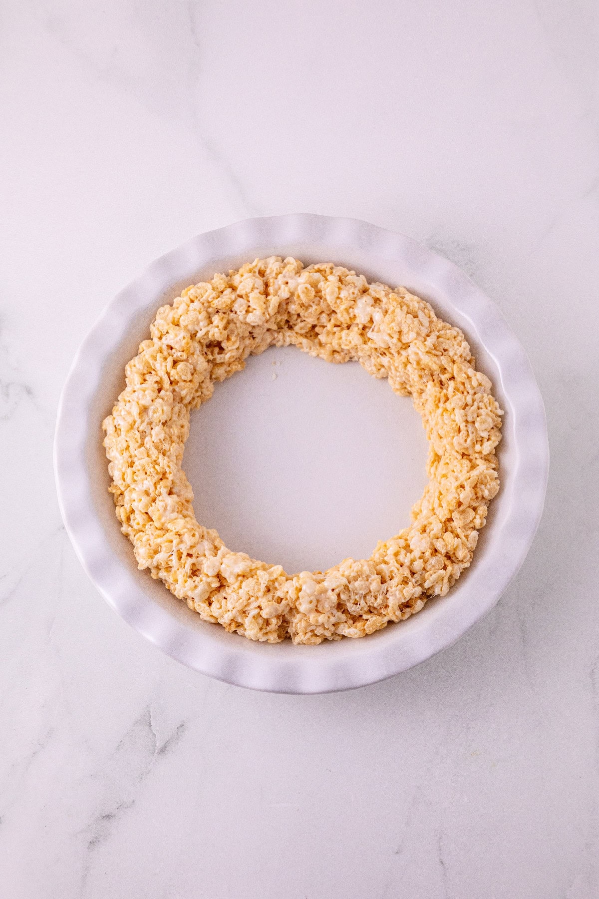 Rice Krispie mixture pressed around the edge of a pie pan to form the crust.
