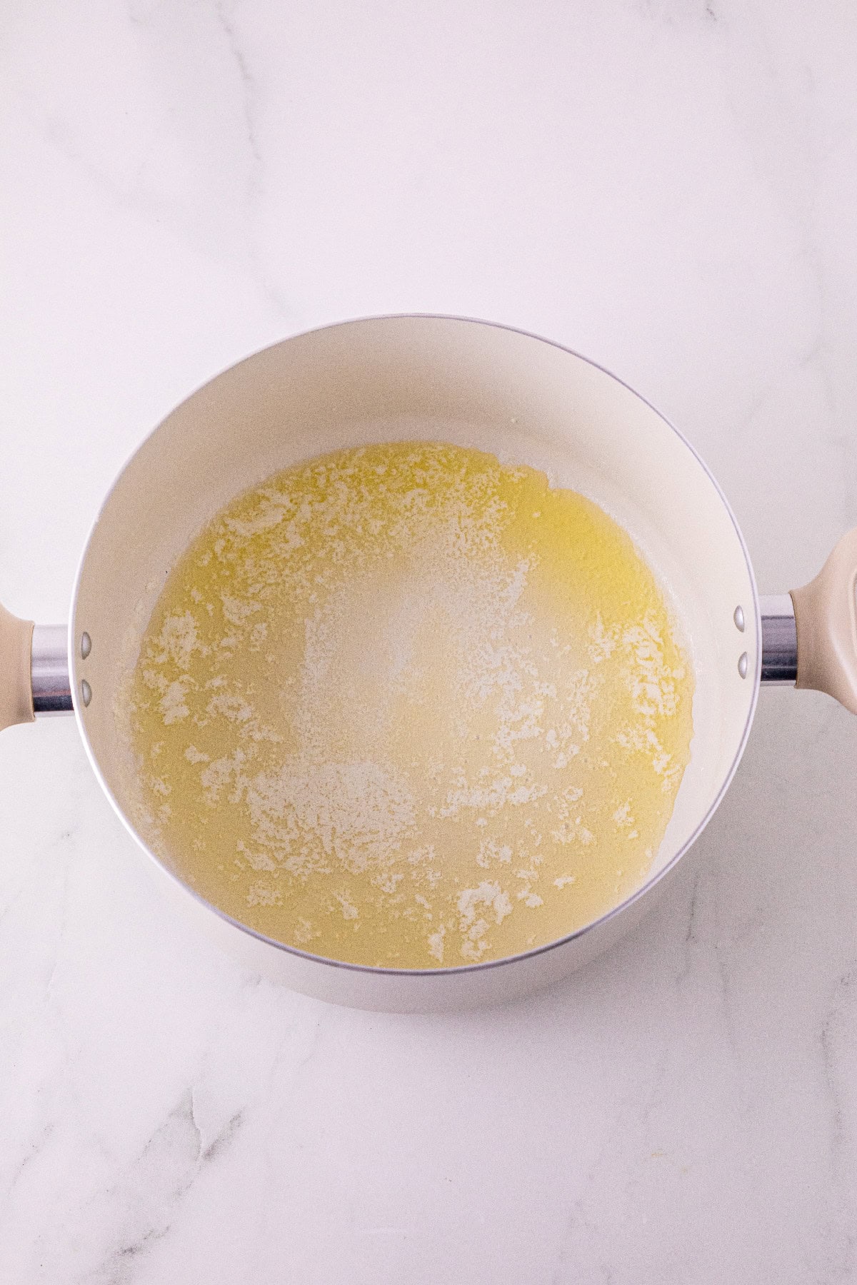 Butter melting in a saucepan for the pumpkin spice filling.