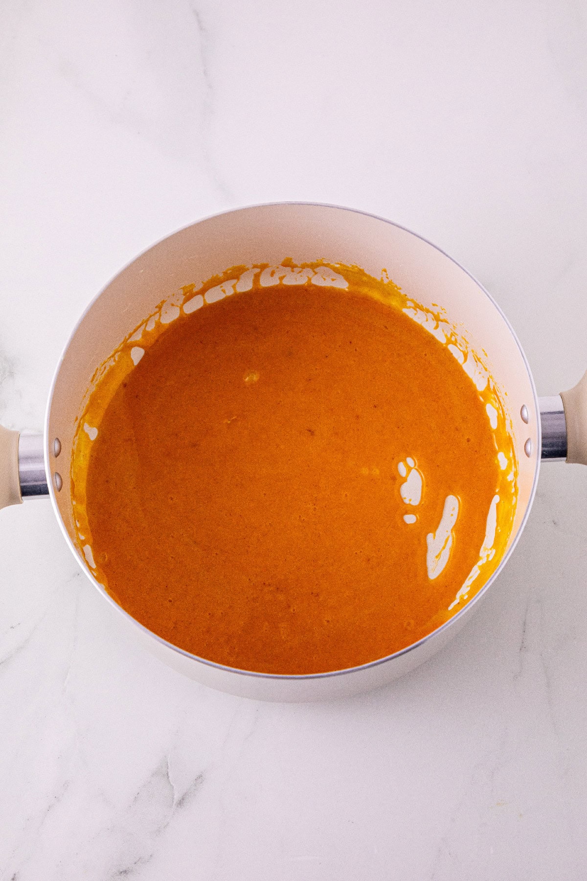Smooth orange pumpkin marshmallow mixture in a saucepan.