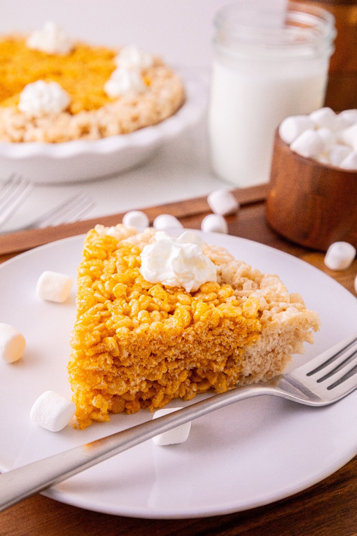 Side view of a pumpkin spice Rice Krispie treat slice showing its thick, crispy texture.