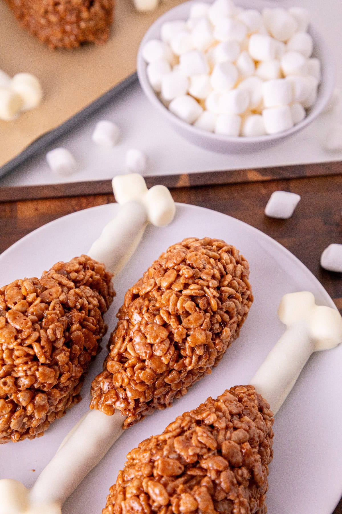 Chocolate Rice Krispie turkey leg treats arranged with white pretzel bones.