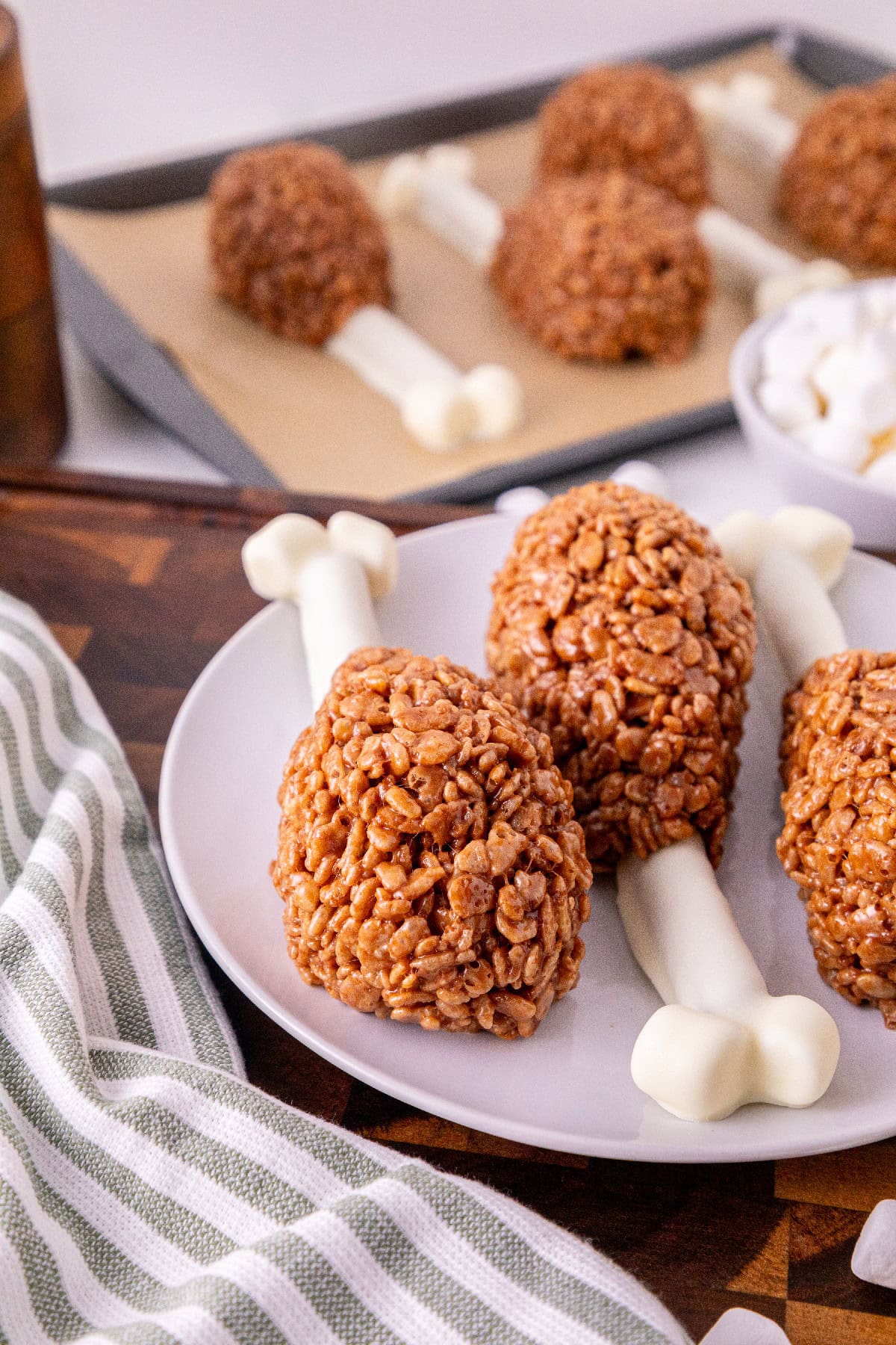 Rice Krispie turkey leg treats with coated pretzel bones on a serving plate.