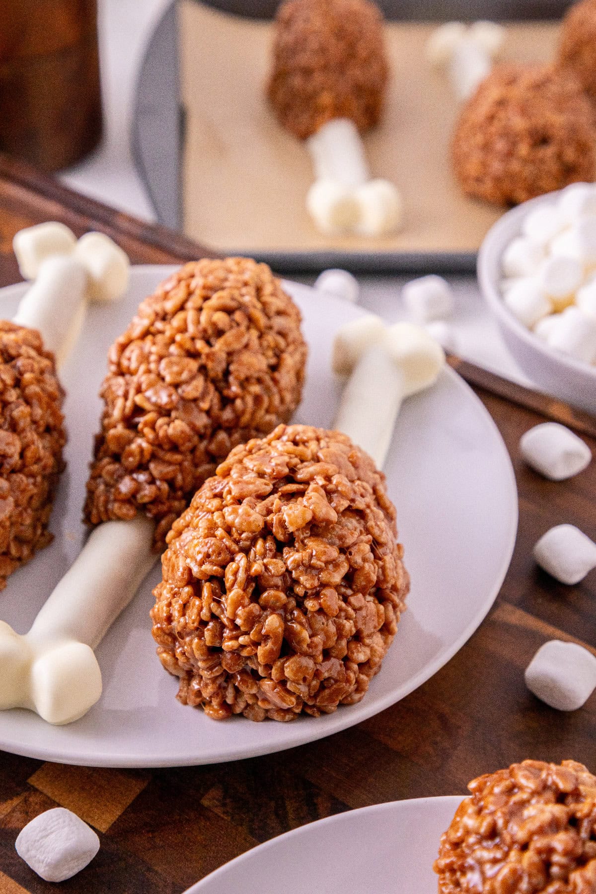 Close-up of homemade Rice Krispie turkey leg treats on a plate.