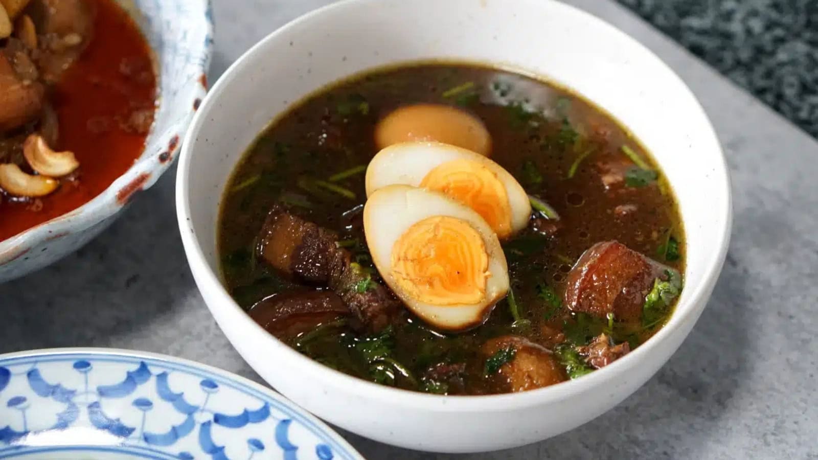 Tender braised pork belly served with eggs in a rich Thai-style sauce.