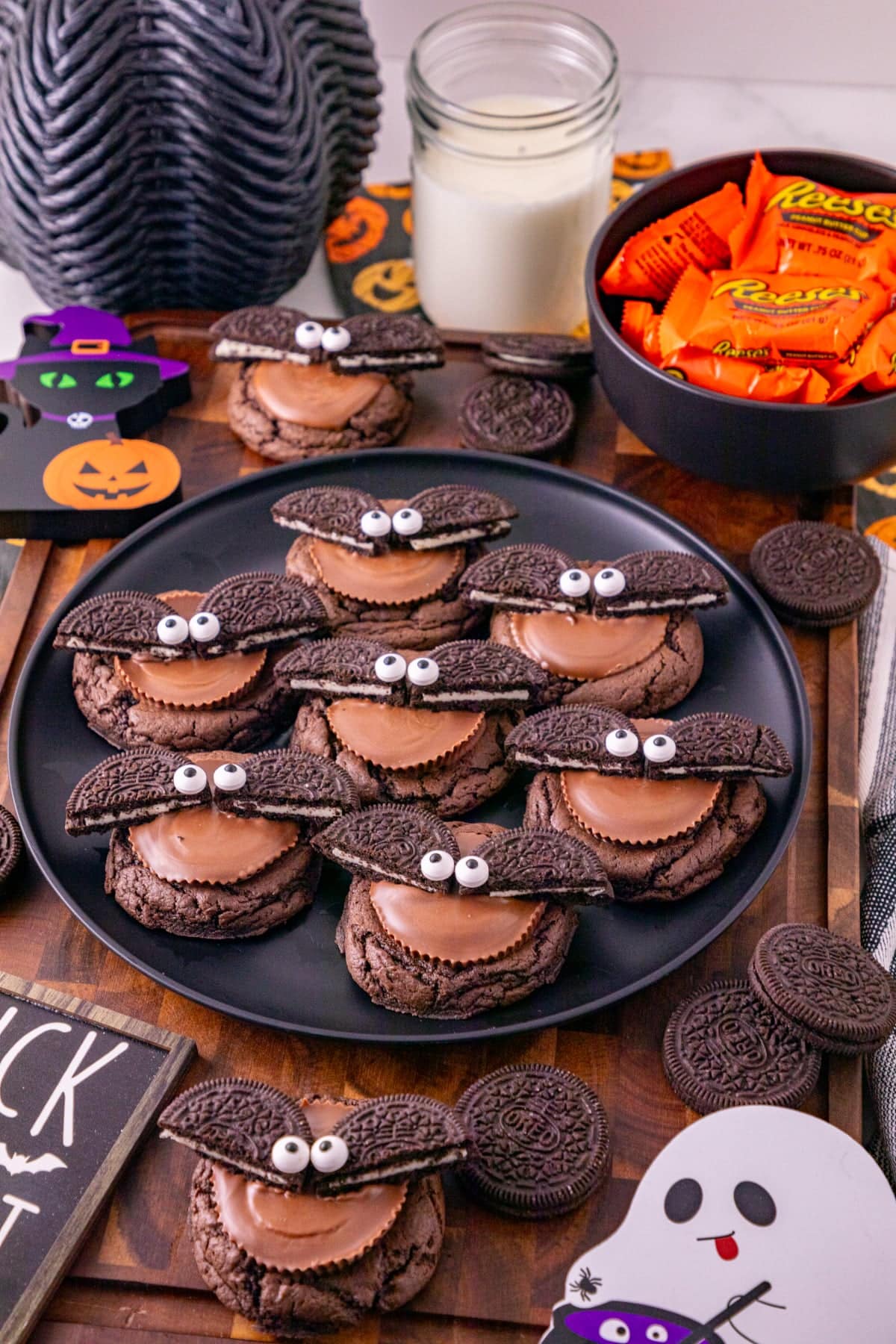 Halloween Oreo bat cookies made with chocolate cookies, Reese’s peanut butter cups, Oreo wings, and candy eyes.