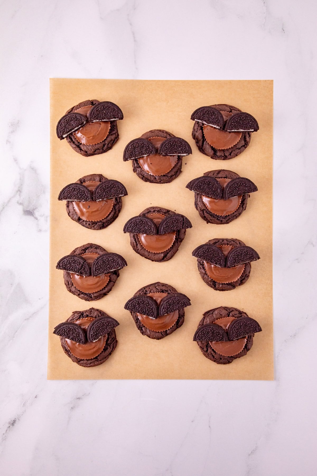 Chocolate cookies topped with Reese’s peanut butter cups and Oreo halves to form bat wings.