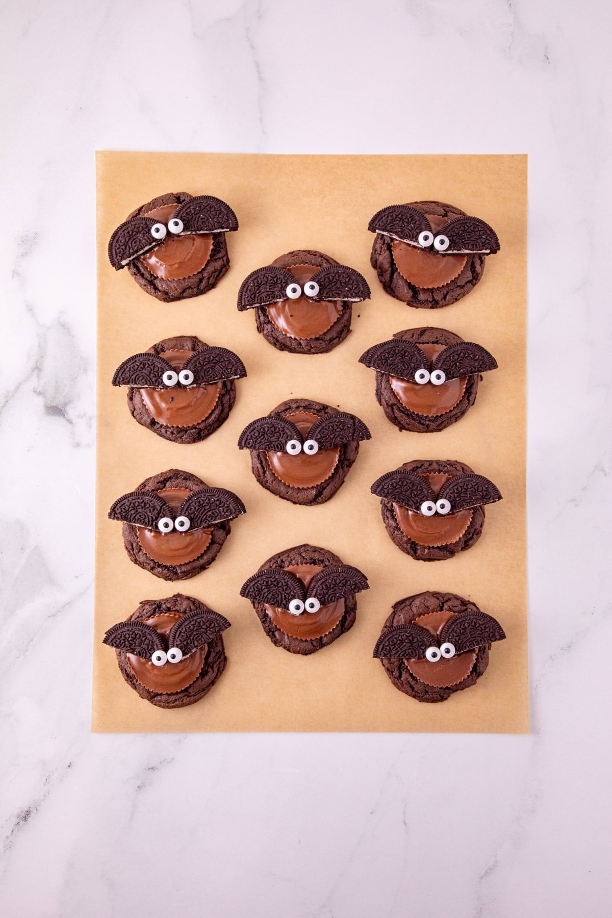 Oreo bat cookies decorated with Reese’s peanut butter cups, Oreo wings, and candy eyes.