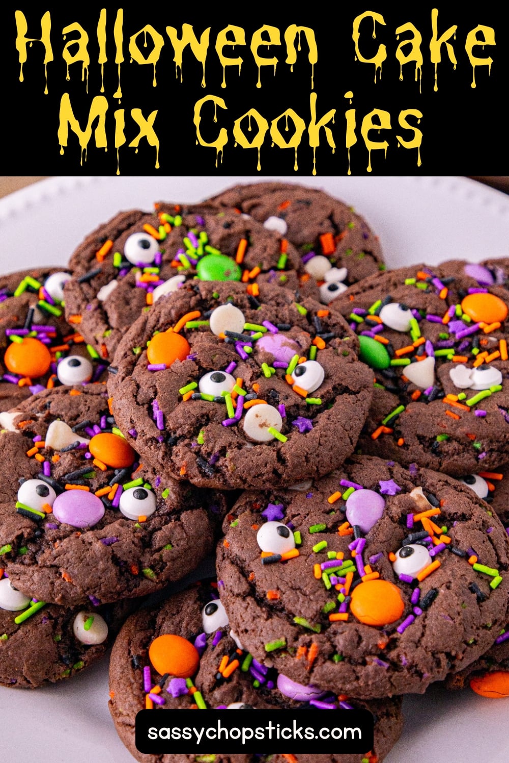 Halloween cake mix cookies topped with candy eyes, sprinkles, and colorful candy.