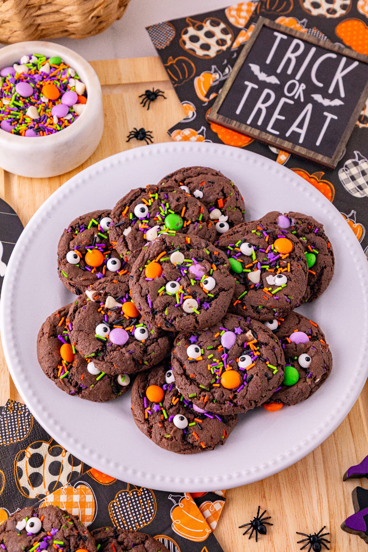 Halloween cake mix cookies topped with candy eyes, sprinkles, and colorful candies.
