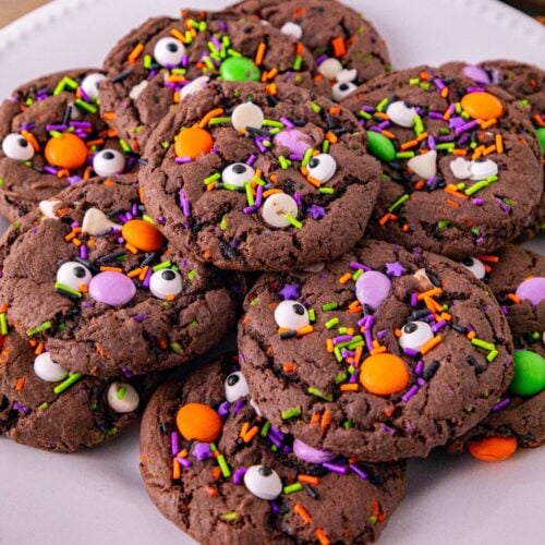 Halloween cake mix cookies with candy eyes, colorful sprinkles, and Halloween candy pieces.