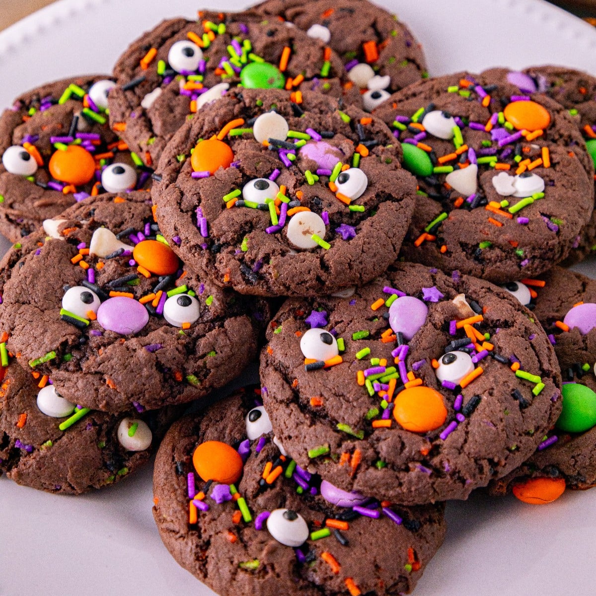 Halloween cake mix cookies with candy eyes, colorful sprinkles, and Halloween candy pieces.