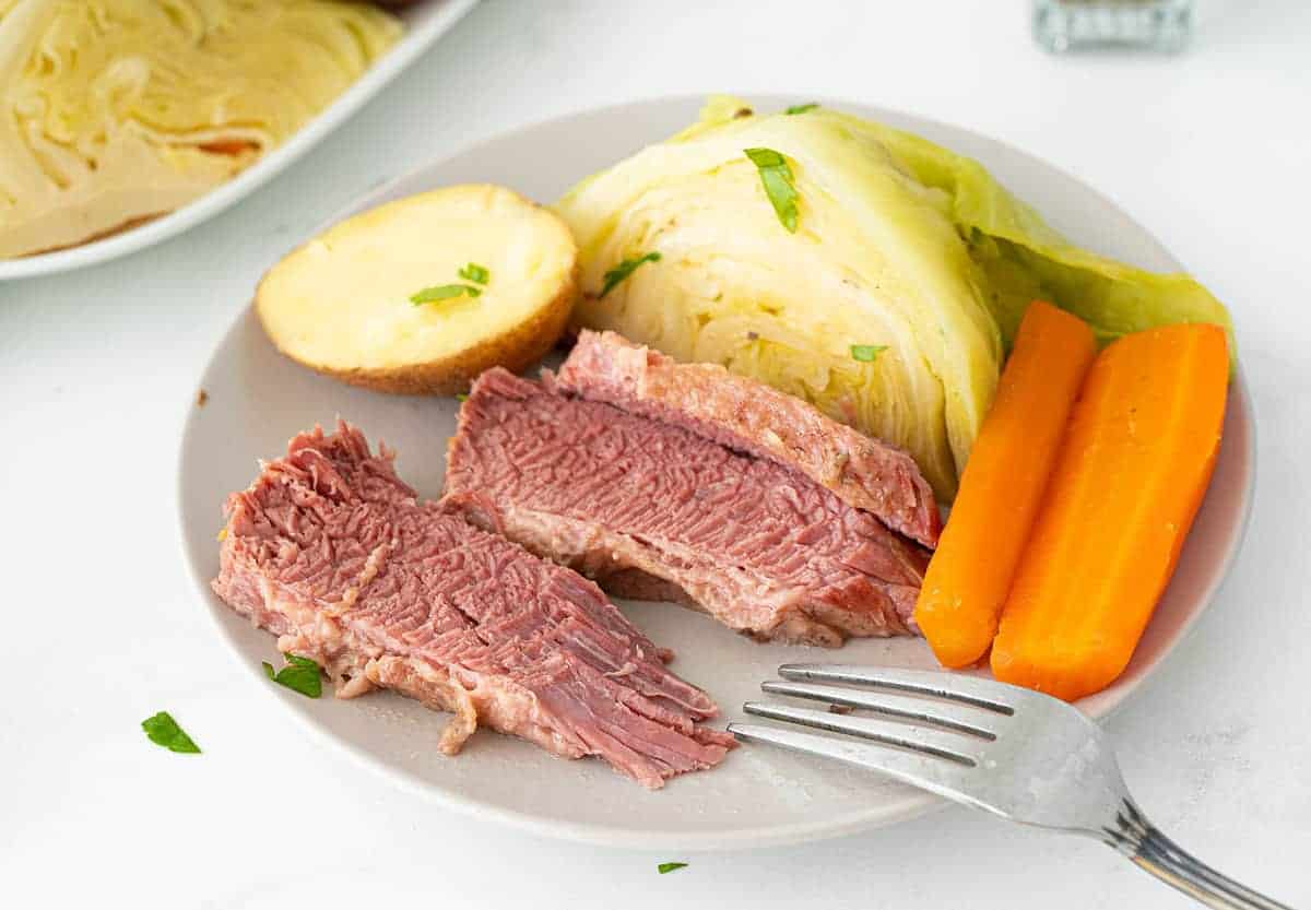 Sliced corned beef with cabbage and potatoes.